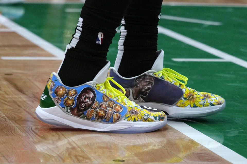 Boston Celtics guard Jaylen Brown wears shoes honoring Celtics great and Hall of Fame center Bill Russell during the first half of Game 1 in the NBA basketball Eastern Conference semifinals playoff series, Monday, May 1, 2023, in Boston. (AP Photo/Charles Krupa)