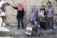 People hold posters of army chief General Abdel Fattah al-Sisi at a rally on Friday in Cairo. Saturday's bloodshed came hours after the military-backed interior minister, Mohammed Ibrahim, warned a long-running sit-in by Morsi loyalists at Rabaa al-Adawiya would be ended following a night of protests by hundreds of thousands of the Islamist's supporters and opponents