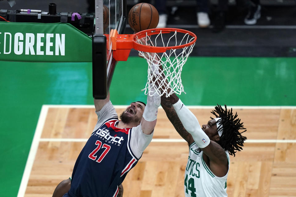 Washington Wizards center Alex Len (27) and Boston Celtics center Robert Williams III (44) vie for a rebound during the first half of an NBA basketball Eastern Conference play-in game Tuesday, May 18, 2021, in Boston. (AP Photo/Charles Krupa)