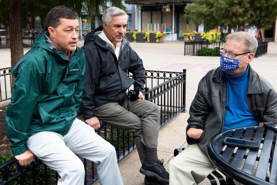 Spark board member Eric Vreeland, right, talks with City of Knoxville's Public Service Director Chad Weth and Downtown Coordinator Rick Emmett in Market Square Oct. 28, 2021.