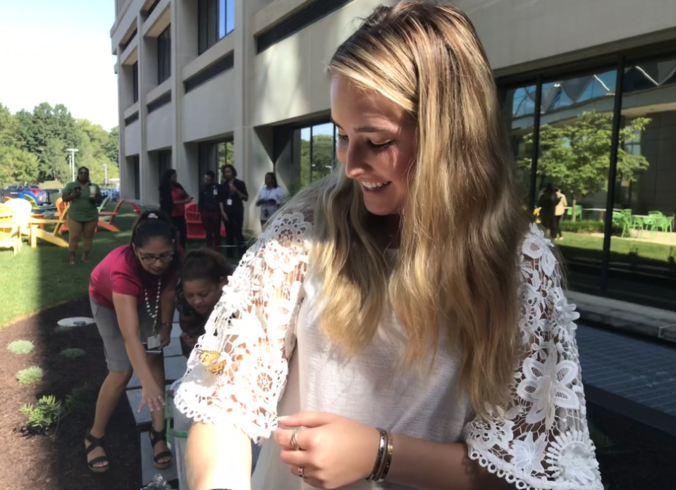 A painted lady butterfly takes refuge on Kendra Kaericher's shirt. The teen helped raise over 200 caterpillars to butterflies to give back to her community.