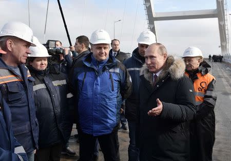 Russian President Vladimir Putin inspects the completed road section of the Crimea Bridge over the Kerch Strait, Crimea, March 14, 2018. Sputnik/Aleksey Nikolskyi/Kremlin via Reuters