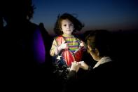 <p>A little girl arrives in Greece as a refugee after making the perilous sea journey from the Middle East. (Angelos Tzortzinis/SWPA) </p>