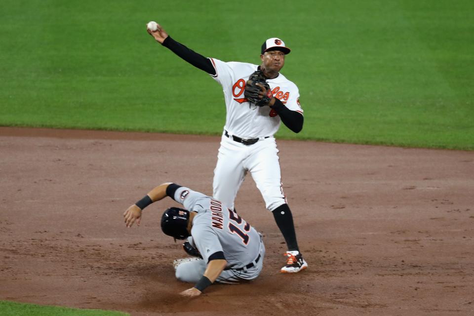 Jonathan Schoop throwing to first and acting as the filling in the Orioles’ triple play sandwich. (Getty Images)