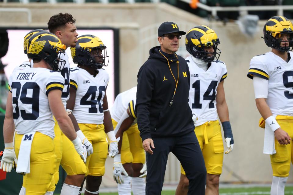 Michigan Wolverines head coach Jim Harbaugh watches his team warm up before playing the Michigan State Spartans, Saturday, Oct. 30, 2021.