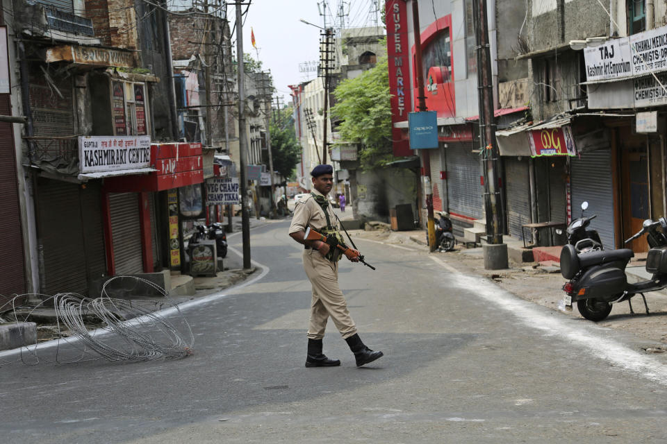 An Indian paramilitary soldier guards during security lockdown in Jammu, India, Tuesday, Aug.6, 2019. India's lower house of Parliament was set to ratify a bill Tuesday that would downgrade the governance of India-administered, Muslim-majority Kashmir amid an indefinite security lockdown in the disputed Himalayan region. The Hindu nationalist-led government of Prime Minister Narendra Modi moved the "Jammu and Kashmir Reorganization Bill" for a vote by the Lok Sahba a day after the measure was introduced alongside a presidential order dissolving a constitutional provision that gave Kashmiris exclusive, hereditary rights. (AP Photo/Channi Anand)