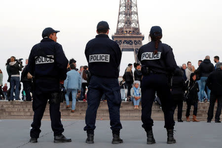 Police patrol at the Trocadero near the Eiffel Tower after a policeman was killed and two others were wounded in a shooting incident in Paris, France, April 21, 2017. REUTERS/Charles Platiau