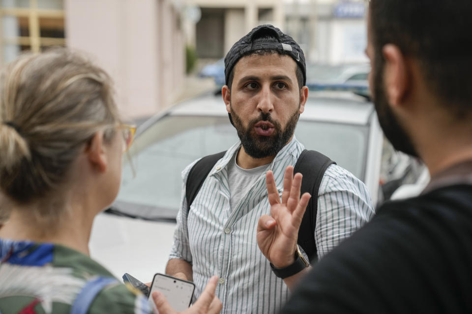 Kassem Abo Zeed, husband of Ezra, who is missing after a fishing boat carrying migrants sank off southern Greece, gestures as he speaks, in the southern port city of Kalamata, Thursday, June 15, 2023. Abo Zeed traveled from Hamburg, Germany, to try and find his wife and her missing brother, Abdullah Aoun. (AP Photo/Thanassis Stavrakis)