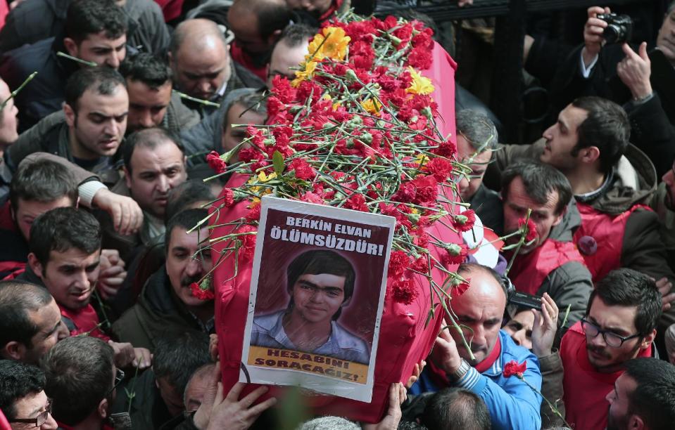 People carry the coffin of Berkin Elvan, a Turkish teenager who was in a coma since being hit on the head by a tear gas canister fired by police during anti-government protests in the summer of 2013, during his funeral in Istanbul, Turkey, Wednesday, March 12, 2014. On Wednesday, thousands converged in front of a house of worship calling for Prime Minister Recep Tayyip Erdogan to resign.(AP Photo/Emrah Gurel)