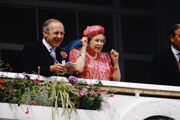 <p>Horse racing was Queen Elizabeth II's big sporting love. Here she is seen cheering on her horses at The Derby Races with her private secretary, Sir William Heseltine.</p>