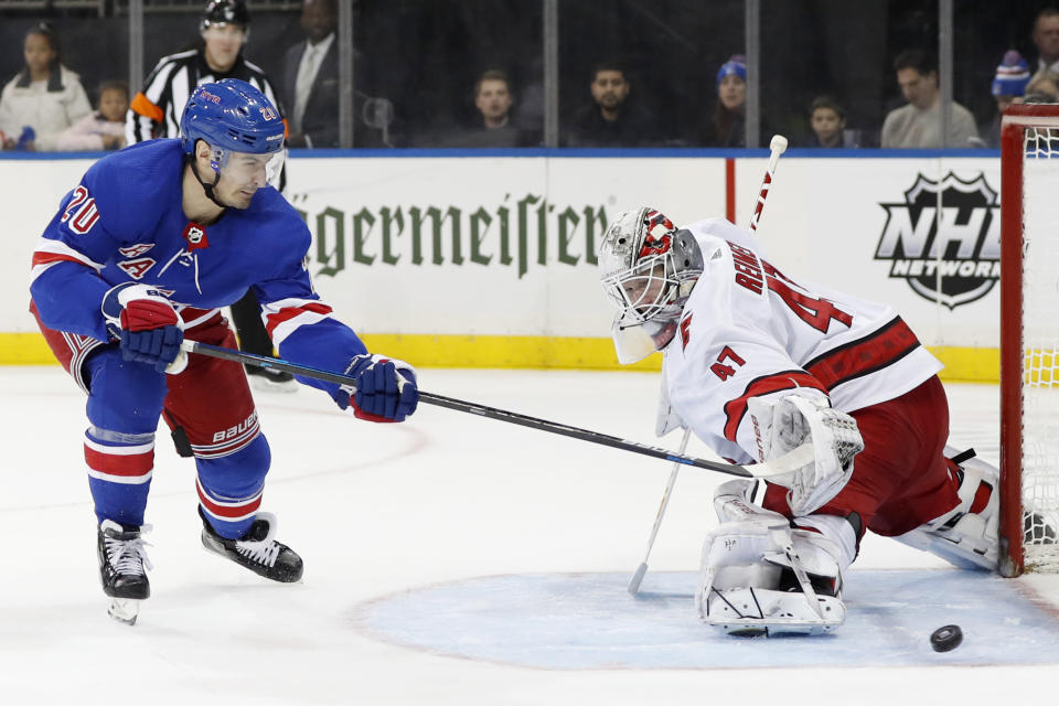 Carolina Hurricanes goaltender James Reimer (47) turns away a shot by New York Rangers left wing Chris Kreider (20) during the second period of an NHL hockey game Friday, Dec. 27, 2019, in New York. (AP Photo/Kathy Willens)