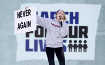 <p>Singer Miley Cyrus holds up a “Never Again” sign as she performs the song “The Climb” as students and gun control advocates hold the “March for Our Lives” rally in Washington. (Aaron P. Bernstein/Reuters) </p>