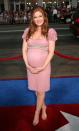 <p>Isla Fisher proudly showed off her bump in a formfitting empire waist dress.</p>