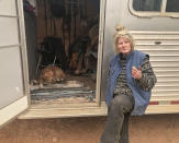 <p>Cathy Fallon sits near her dog Shiloh, a 2-year-old golden retriever, whose face was burned in the fire in Paradise, Calif. Nov. 10, 2018. Shiloh needs veterinarian treatment. But she can’t leave her property because authorities won’t allow her to return to Paradise, since the entire town is still under an evacuation order. Fallon and Shiloh are spending nights in this horse trailer because the family home burned. (Photo: Paul Elias/AP) </p>