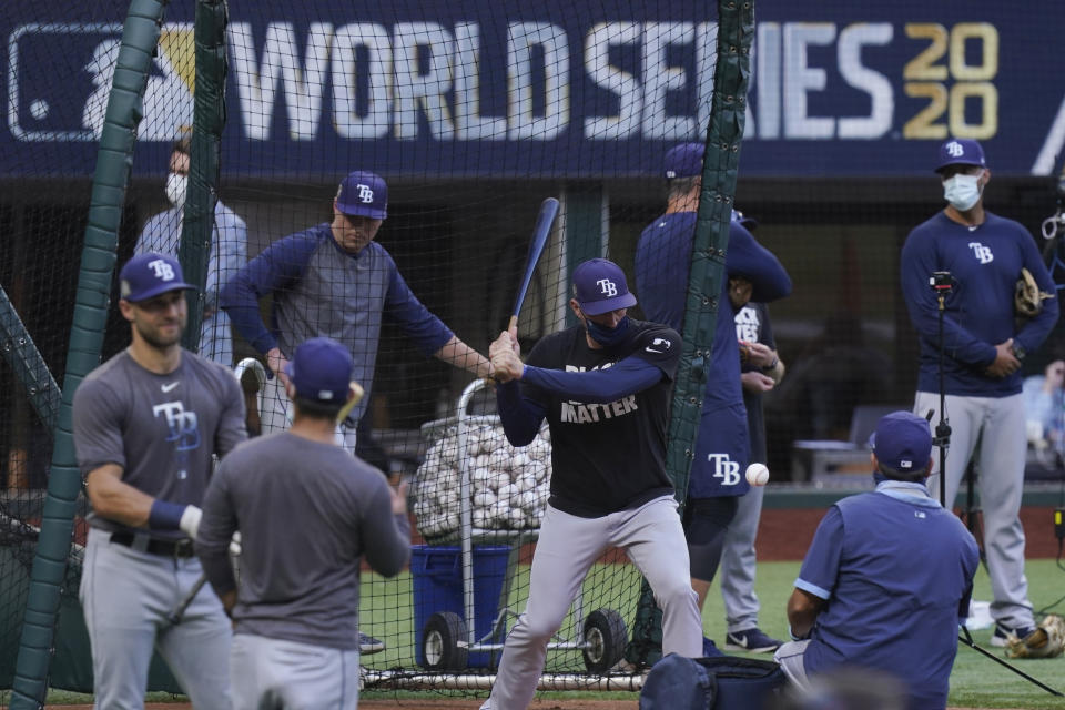 Members of the Tampa Bay Rays warms up during batting practice before Game 1 of the baseball World Series against the Los Angeles Dodgers Tuesday, Oct. 20, 2020, in Arlington, Texas. (AP Photo/Eric Gay)