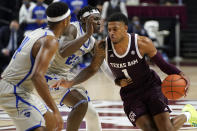 Texas A&M guard Savion Flagg (1) drives the lane against New Orleans forward LaDarius Marshall (23) during the second half of an NCAA college basketball game Sunday, Nov. 29, 2020, in College Station, Texas. (AP Photo/Sam Craft)