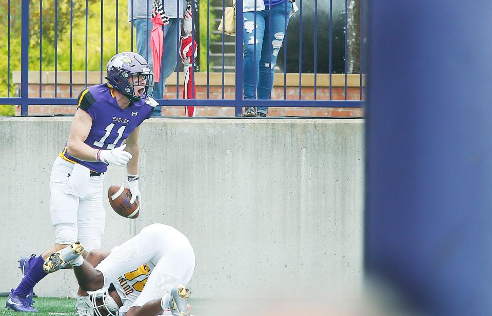 Ashland University's Jake McLoughlin (11) celebrates after scoring the team's second touchdown, bringing the score to 13-3, in the second quarter of the game against Quincy University, Saturday, Sept. 25, 2021.