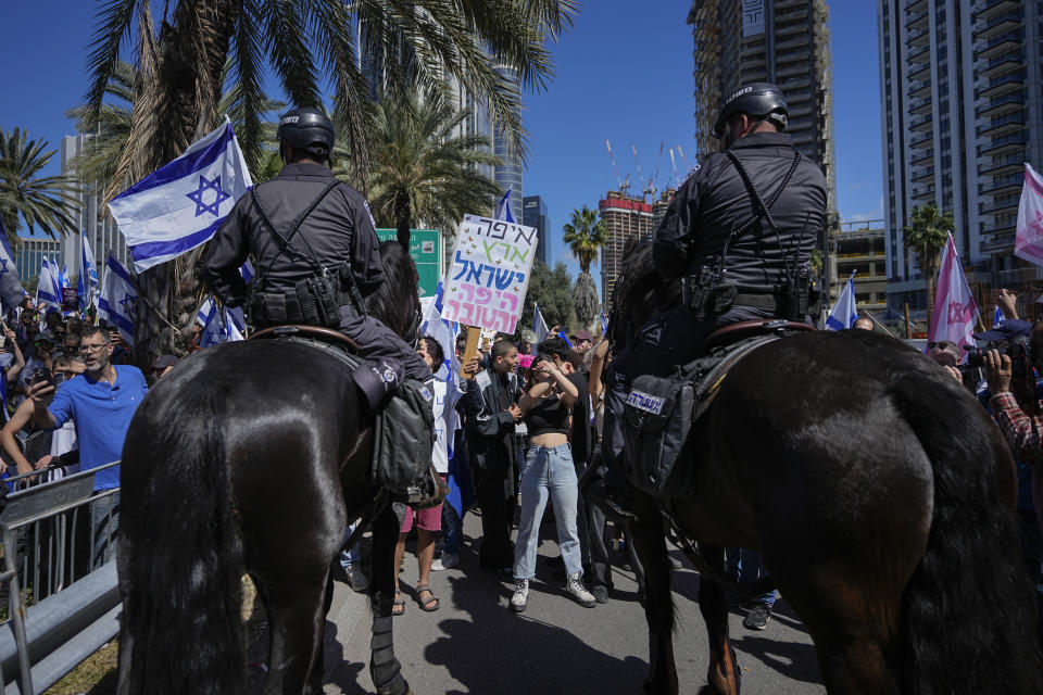 Mounted police are deployed as Israelis block a main road to protest against plans by Prime Minister Benjamin Netanyahu's new government to overhaul the judicial system, in Tel Aviv, Israel, Thursday, March 9, 2023. (AP Photo/Ohad Zwigenberg)
