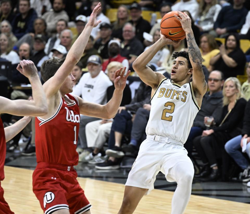 Colorado guard KJ Simpson (2) shoots over Utah guard Ben Carlson (1) in the second half of an NCAA college basketball game Saturday, Feb. 24, 2024, in Boulder, Colo. | Cliff Grassmick, Associated Press