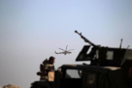 An army military helicopter flies over the Iraqi rapid response forces' position during a battle against Islamic State militants in the south of Mosul, Iraq February 19, 2017. REUTERS/Zohra Bensemra