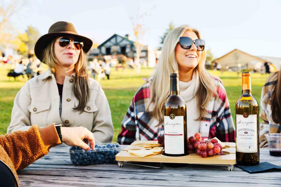 Women enjoy a bottle of wine