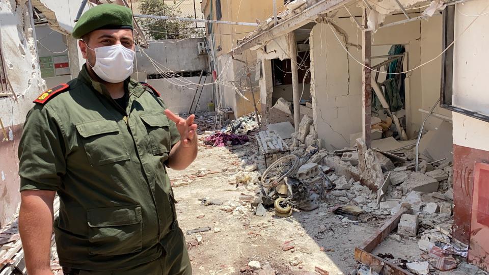 Colonel Mohammed al-Hossein, of the Afrin police, assesses the damage done by a 12 June rocket attack on Al-Shifaa Hospital (Borzou Daragahi)