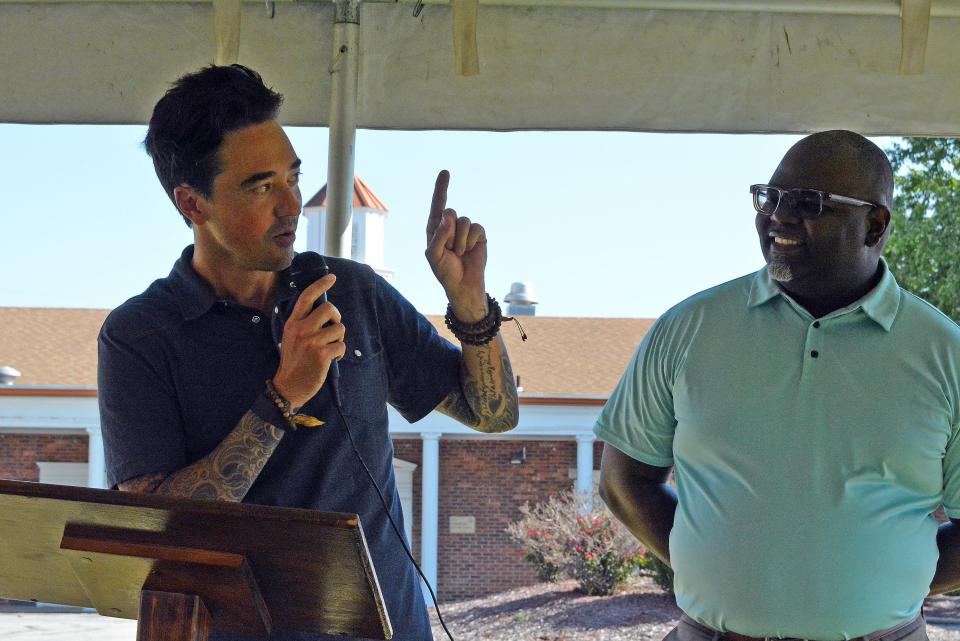 Veterans United Foundation President Erik Morse shares Wednesday with United Community Builders executive director Damian Dean how he used to live in the apartments adjacent to 1801 Towne Drive, which will be the home of UCB's Beacon of Light Community Center.
