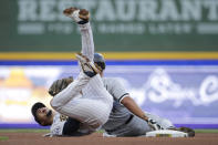 Milwaukee Brewers' Willy Adames, left, reacts after tagging out Chicago White Sox's Jose Abreu at second base during the fourth inning of a baseball game Saturday, July 24, 2021, in Milwaukee. (AP Photo/Aaron Gash)