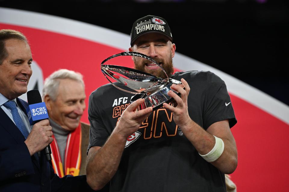 Kansas City Chiefs tight end Travis Kelce (87) holds the Lamar Hunt trophy after winning the AFC Championship.