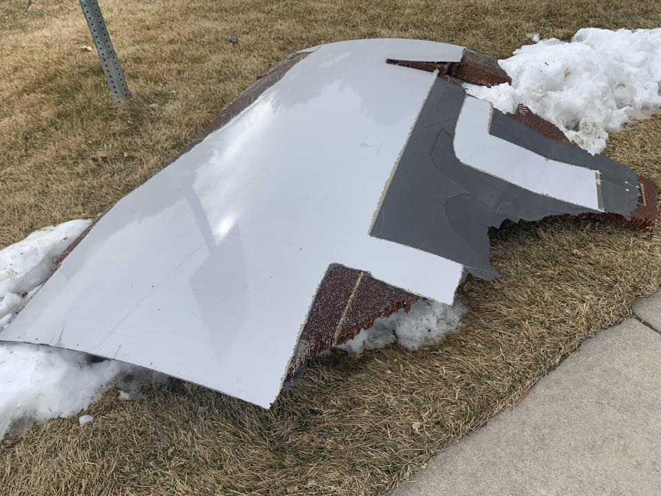 In this photo provided by the Broomfield Police Department on Twitter, debris is scattered across the turf field at Commons Park, Saturday, Feb. 20, 2021, in Broomfield, Colo. The police ask that the area be avoided if possible. A commercial airliner dropped debris in Colorado neighborhoods during an emergency landing Saturday. The Broomfield Police Department said on Twitter that the plane landed safely at Denver International Airport and that no injuries had been reported from the incident. (Broomfield Police Department via AP)