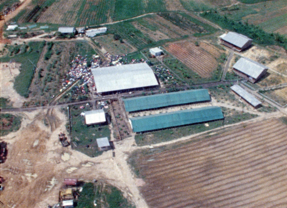 The Peoples Temple compound is seen in aerial view as helicopters approach Jonestown. <span class="copyright">Courtesy of Hulu via National Archives and Records Administration</span>