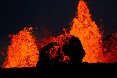 Lava from the Kilauea volcano shoots out of a fissure, in the Leilani Estates near Pahoa, Hawaii, U.S., May 26, 2018. REUTERS/Marco Garcia