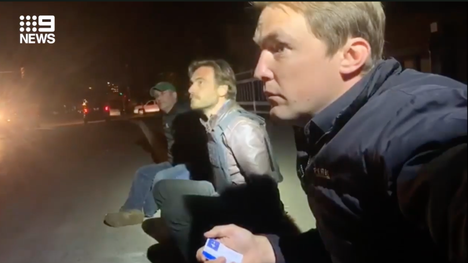 Tim Arvier sits with handcuffed colleagues in Minneapolis after being detained by police as the widespread protests over the death of George Floyd continue.