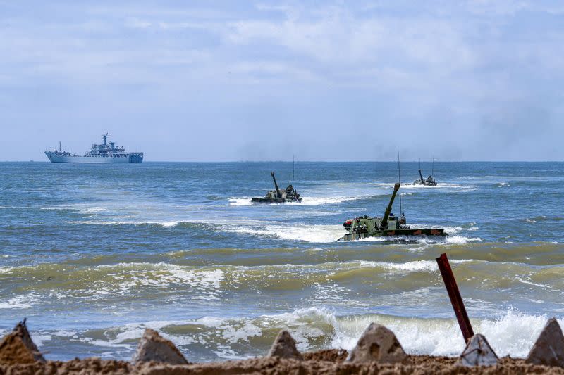 FILE PHOTO: PLA amphibious armoured vehicles take part in an exercise in Zhangzhou