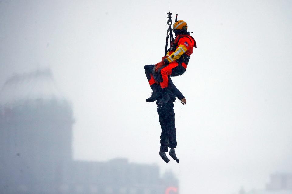 coast guard rescuer pulls woman from submerged car