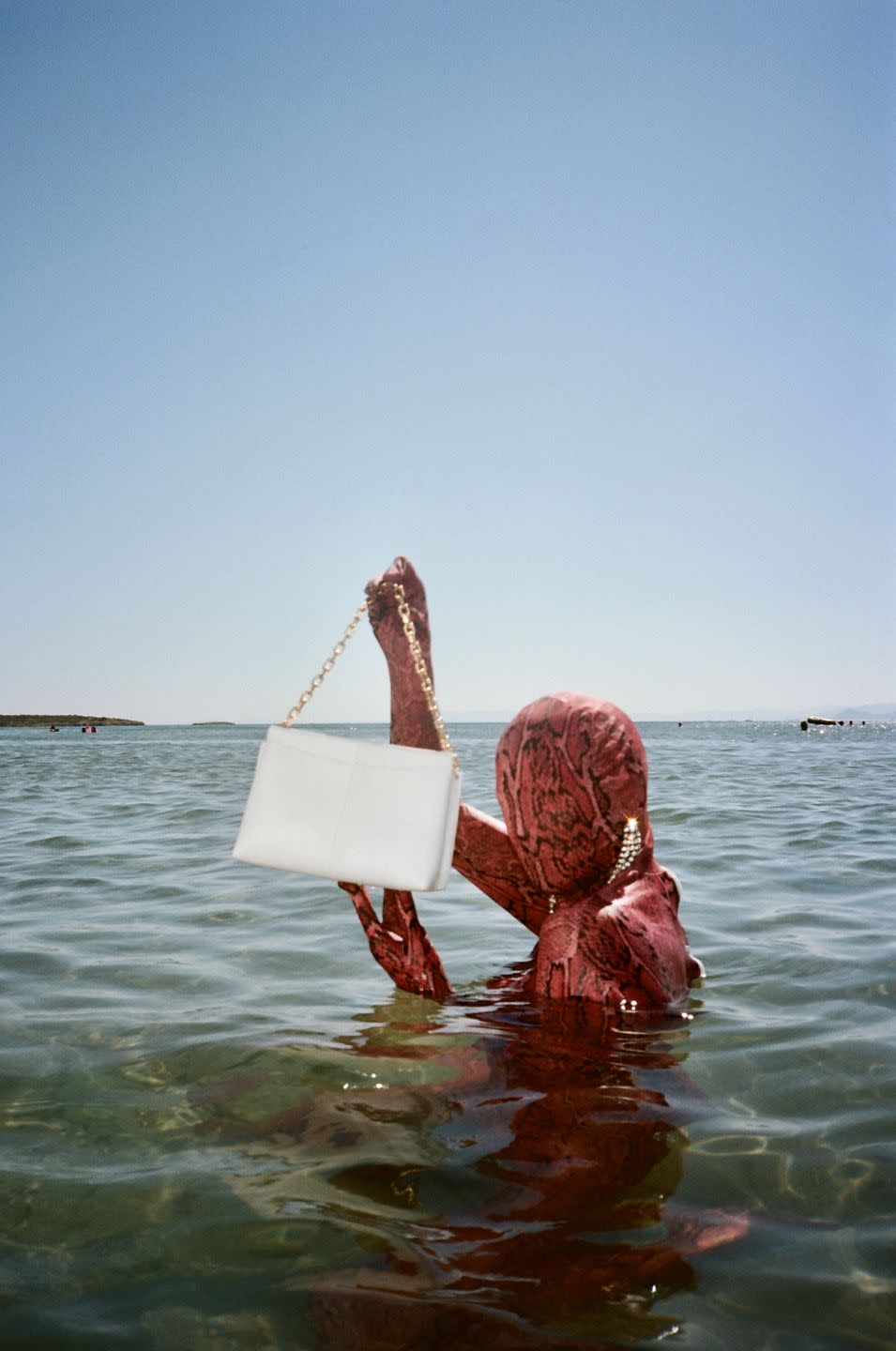 <p>The Dutch accessories and footwear brand, founded by Elza Wandler in 2017, bids farewell to summer 2020 in style with a campaign by Checking Invoices.</p><p>The anonymous photographic duo maintains the mystery with a model shot in a reptilian morph suit (chic), placing attention fully on the bags and shoes. Which you can buy <a href="https://wandler.com/" rel="nofollow noopener" target="_blank" data-ylk="slk:here;elm:context_link;itc:0;sec:content-canvas" class="link ">here</a>, just FYI.</p>