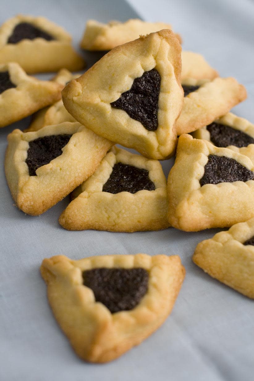 This image taken on Jan. 30, 2012 in Concord, N.H. shows triangular-shaped orange-poppy seed hamantashen cookies, a favorite for the Jewish holiday Purim. (AP Photo/Matthew Mead)