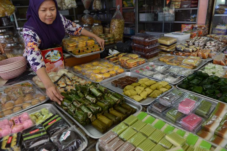 A vendor arranges a display of fresh local snacks at a market in Jakarta on November 28, 2014