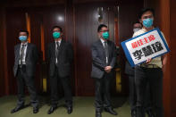 Pro-democracy lawmaker Eddie Chu, right, holds a placard reading "Best Chairperson, Starry Lee” as he stands outside the chamber of Legislative Council Complex after he was ejected minutes after a second-day legislative debate in Hong Kong Thursday, May 28, 2020. Chu was ejected from the legislative chamber, disrupting the start of the debate on a contentious bill that would criminalize insulting or abusing the Chinese national anthem. Lee was recently elected chair of a key committee that sent the anthem bill to the full legislature for consideration. (AP Photo/Vincent Yu)