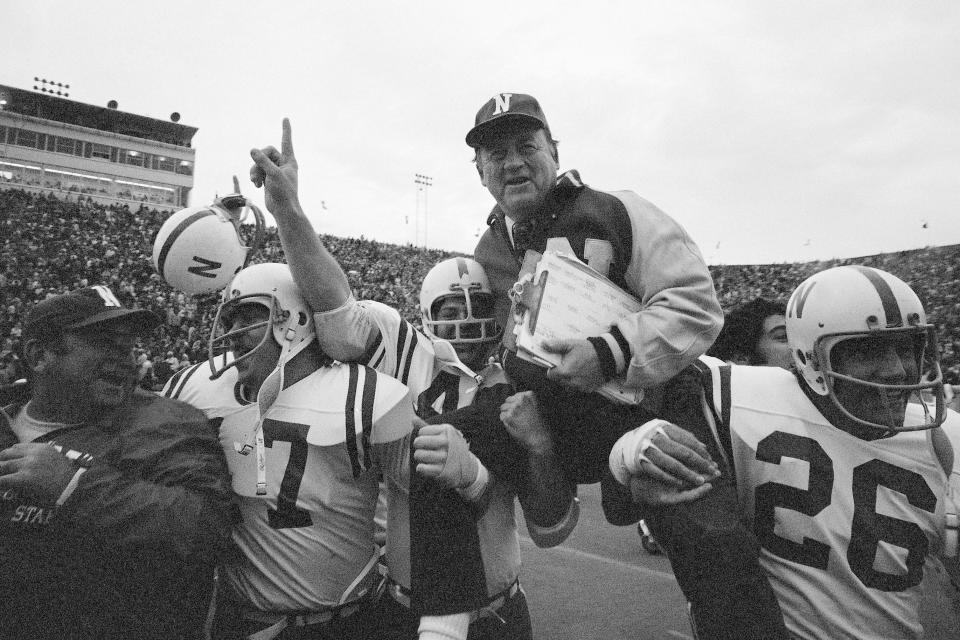 FILE - In this Nov. 25, 1971, file photo, Nebraska head coach Bob Devaney is carried off the field by his victorious players after Nebraska defeated Oklahoma 35-31 in an NCAA college football game in Norman, Okla. Reports that Nebraska wants to back out of playing at Oklahoma this season didn't sit well with one of the stars of the 1971 Game of the Century. The game scheduled Sept. 18 in Norman, Oklahoma, would mark the 50th anniversary of Nebraska's 35-31 win over the Sooners in a clash of the Nos. 1 and 2 teams in the nation. (AP Photo/File)