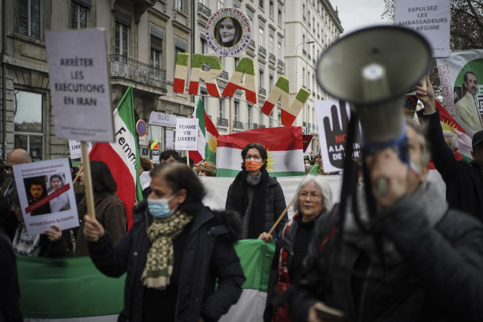 People demonstrate in Lyon, central France, Sunday, Jan. 8, 2023. Hundreds of people marched Sunday in France to honor an Iranian Kurdish man who took his own life in a desperate act of anguish over the nationwide protests in Iran. Police estimated the size of the crowd that gathered for Mohammad Moradi at about 1,000 people. They marched in the city of Lyon, where the 38-year-old Moradi took his own life in December, drowning in the Rhone river. (AP Photo/Laurent Cipriani)