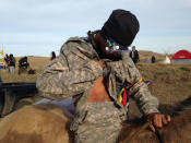 <p>A Dakota Access oil pipeline protester who identified himself only as Smokey shows where he was hit by a shotgun bean bag round fired by officers trying to force protesters from a camp on private land in the path of pipeline construction, on Thursday, Oct. 27, 2016 near Cannon Ball, N.D. (Photo: James MacPherson/AP) </p>