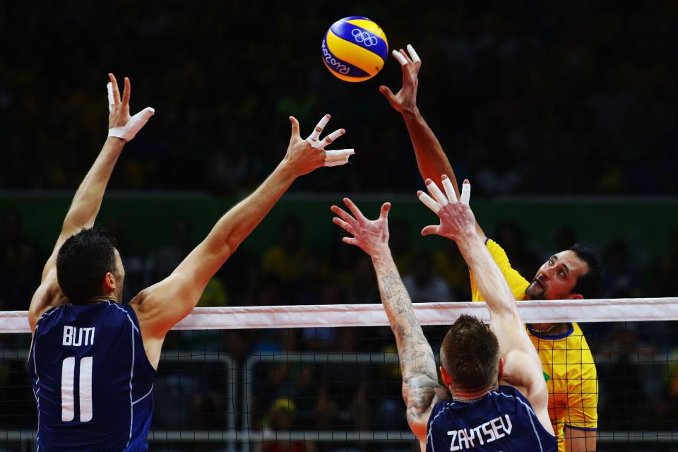 <p>Simone Buti of Italy and Ivan Zaytsev of Italy try to block the spike by Mauricio Luiz de Souza of Brazil during the Men’s Gold Medal Match between Italy and Brazil on Day 16 of the Rio 2016 Olympic Games at Maracanazinho on August 21, 2016 in Rio de Janeiro, Brazil. (Getty) </p>