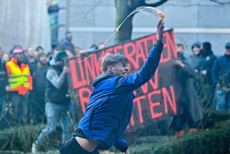 A farmer throws an egg during a protest in the European district, organized by several agriculture unions from Belgium and other European countries, as they demand better conditions to grow, produce and maintain a proper income. Dirk Waem/Belga/dpa
