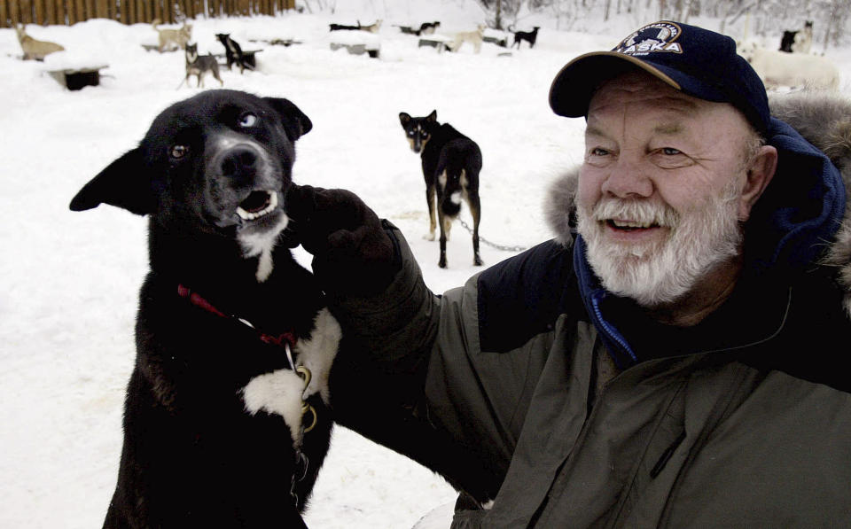 FILE - Author Gary Paulsen sits with his favorite Alaskan husky, Flax, at his Willow, Alaska, home on Feb. 10, 2005. Paulsen died Wednesday, Oct. 13, 2021 at age 82. (AP Photo/Al Grillo, File)