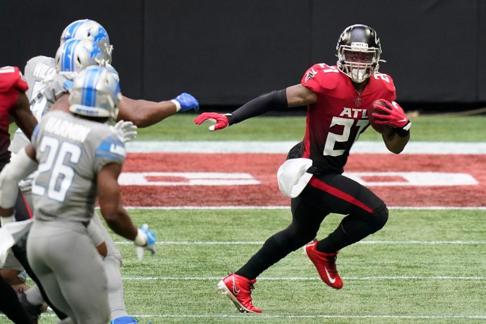 Falcons running back Todd Gurley (21) runs against the Lions during the first half on Sunday, Oct. 25, 2020, in Atlanta.