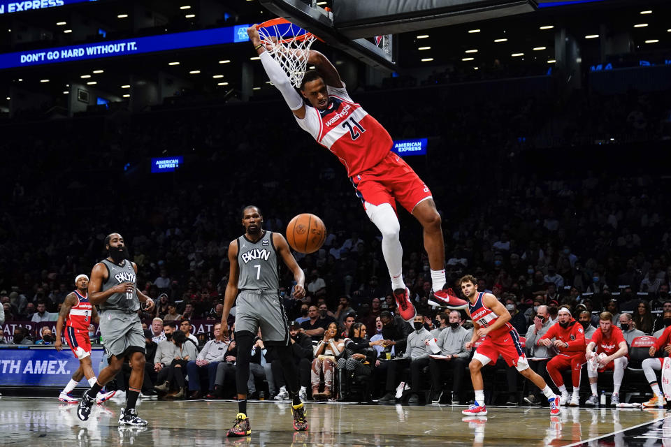 Washington Wizards' Daniel Gafford (21) dunks in front of Brooklyn Nets' Kevin Durant (7) during the first half of an NBA basketball game Monday, Oct. 25, 2021, in New York. (AP Photo/Frank Franklin II)