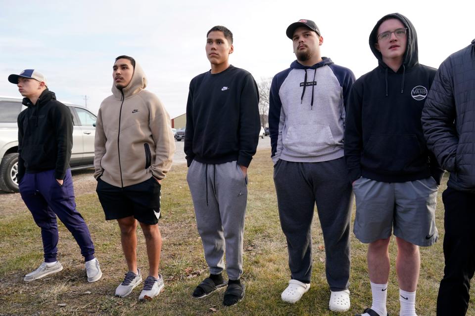 Perry High School junior Samuel Hernandez, center, listens to a news conference following a shooting at Perry High School, Thursday, Jan. 4, 2024, in Perry, Iowa. (AP Photo/Charlie Neibergall)