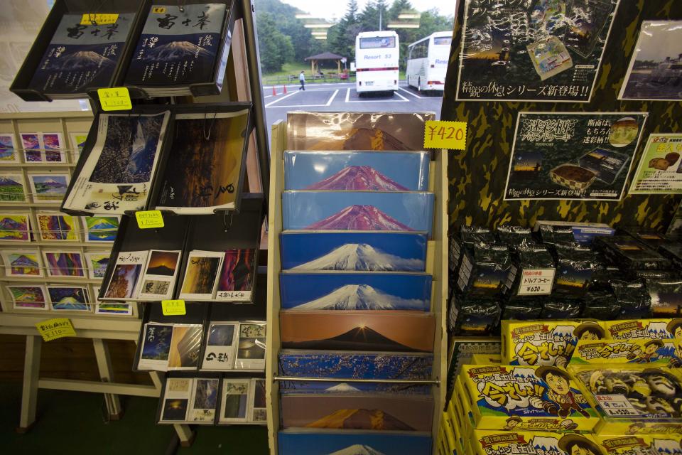 In this Thursday, Aug. 29, 2013 photo, Mount Fuji souvenirs sit on shelves for sale at a shop at the base of the mountain in Japan. The Japanese cheered the recent recognition of Mount Fuji as a UNESCO World heritage site, though many worry that the status may worsen the damage to the environment from the tens of thousands who visit the peak each year. (AP Photo/David Guttenfelder)