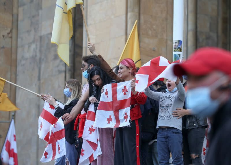 Opposition supporters attend a rally following the announcement of parliamentary election preliminary results